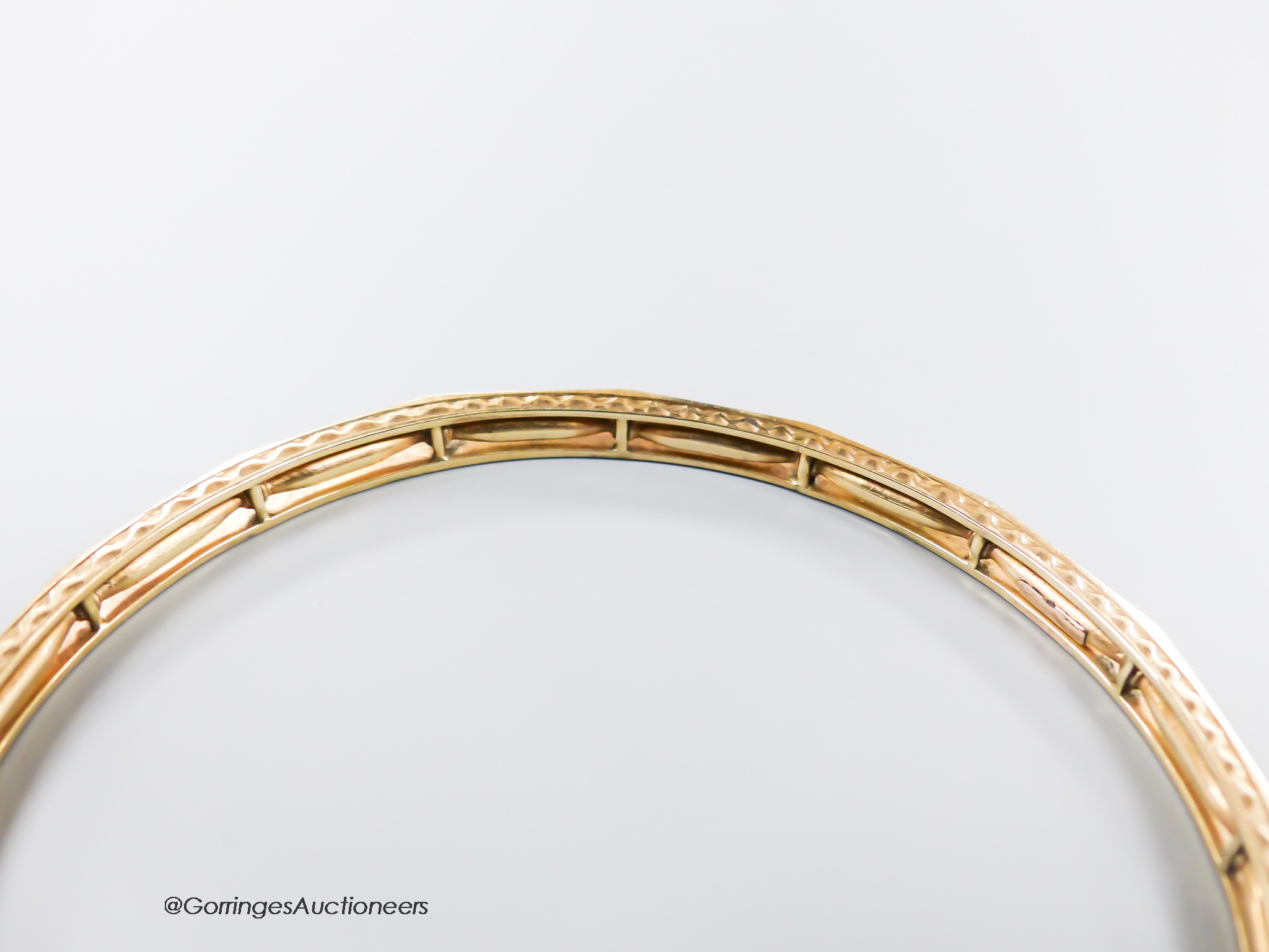 A pierced 9ct bangle, interior diameter 68mm, 13.2 grams.